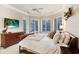Spacious main bedroom with a king-size bed and large TV at 2867 Grey Oaks Blvd, Tarpon Springs, FL 34688