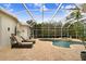 Relaxing pool area with covered patio, lounge chairs, and spa at 2867 Grey Oaks Blvd, Tarpon Springs, FL 34688