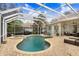 Resort style pool and spa with covered patio and outdoor seating at 2867 Grey Oaks Blvd, Tarpon Springs, FL 34688