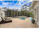 Enclosed pool and spa with patio furniture and grill at 2867 Grey Oaks Blvd, Tarpon Springs, FL 34688