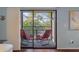 Screened balcony with two red chairs and view of trees at 314 Moorings Cove Dr, Tarpon Springs, FL 34689