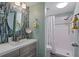 Updated bathroom with walk-in shower, mosaic tile and gray vanity at 314 Moorings Cove Dr, Tarpon Springs, FL 34689