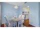 Bright dining area with a gray table and four chairs, view into updated kitchen at 314 Moorings Cove Dr, Tarpon Springs, FL 34689