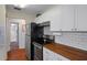 Modern kitchen with stainless steel appliances and wood countertops at 314 Moorings Cove Dr, Tarpon Springs, FL 34689