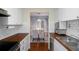 Modern kitchen features white cabinets, butcher block countertops, and a view to the dining area at 314 Moorings Cove Dr, Tarpon Springs, FL 34689