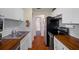 Updated kitchen with butcher block countertops, white cabinets, and stainless steel appliances at 314 Moorings Cove Dr, Tarpon Springs, FL 34689
