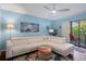 Living room with white sectional sofa and ceiling fan at 314 Moorings Cove Dr, Tarpon Springs, FL 34689