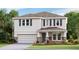 Two-story house with stone accents and a two-car garage at 3550 Thistle Bank Ct, Plant City, FL 33565