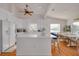 Modern white kitchen with large island and hardwood floors at 4207 Des Prez Ct, Hernando Beach, FL 34607