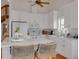 White kitchen with island, stainless steel appliances, and hardwood floors at 4207 Des Prez Ct, Hernando Beach, FL 34607