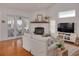 Living room with hardwood floors, fireplace, and access to balcony at 4207 Des Prez Ct, Hernando Beach, FL 34607