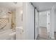 Updated bathroom features marble tile, gold fixtures, and a barn door at 4318 1St S Ave, St Petersburg, FL 33711