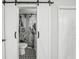 Bathroom with barn door entry and black and white tile floor at 4318 1St S Ave, St Petersburg, FL 33711