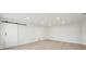 Spacious bedroom with light wood floors and barn door at 4318 1St S Ave, St Petersburg, FL 33711