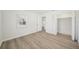 Bedroom with wood-look floors and access to hallway at 4318 1St S Ave, St Petersburg, FL 33711