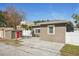House exterior with a red door and a detached shed at 4318 1St S Ave, St Petersburg, FL 33711