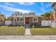 Newly renovated home exterior with a red front door and landscaped yard at 4318 1St S Ave, St Petersburg, FL 33711