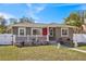 Newly renovated home exterior with a red front door and landscaped yard at 4318 1St S Ave, St Petersburg, FL 33711