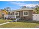 Newly renovated craftsman style home with a red door and white fence at 4318 1St S Ave, St Petersburg, FL 33711
