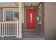 Newly renovated home with a red front door and white porch railing at 4318 1St S Ave, St Petersburg, FL 33711