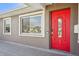 Close-up of the charming red front door and white trim at 4318 1St S Ave, St Petersburg, FL 33711