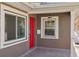 Inviting front porch with a red door and gray stucco exterior at 4318 1St S Ave, St Petersburg, FL 33711
