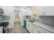 Updated kitchen boasts white cabinets, marble counters & stainless steel appliances at 4318 1St S Ave, St Petersburg, FL 33711