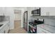 Modern kitchen with white cabinets, stainless steel appliances and marble countertops at 4318 1St S Ave, St Petersburg, FL 33711