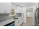 Modern kitchen with white cabinets, stainless steel appliances and marble countertops at 4318 1St S Ave, St Petersburg, FL 33711