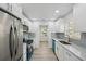 Modern kitchen with white cabinets, stainless steel appliances, and marble countertops at 4318 1St S Ave, St Petersburg, FL 33711