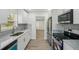 Modern kitchen features white shaker cabinets, marble countertops, and stainless steel appliances at 4318 1St S Ave, St Petersburg, FL 33711