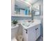 Updated bathroom with vanity, mirror, and white cabinets at 4725 Cove Cir # 211, St Petersburg, FL 33708