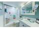 Bathroom with updated vanity and shower at 4725 Cove Cir # 211, St Petersburg, FL 33708