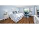 Bright bedroom with wood floors and a workspace at 4725 Cove Cir # 211, St Petersburg, FL 33708