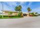 Community building with palm trees and landscaping at 4725 Cove Cir # 211, St Petersburg, FL 33708