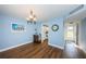 Bright dining room with wood-look floors, and view into kitchen at 4725 Cove Cir # 211, St Petersburg, FL 33708