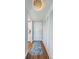 Bright entryway with wood flooring, a runner, and built-in storage at 4725 Cove Cir # 211, St Petersburg, FL 33708