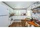 Charming kitchen with white cabinets and modern appliances at 4725 Cove Cir # 211, St Petersburg, FL 33708