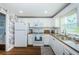 White kitchen with updated appliances and brown countertops at 4725 Cove Cir # 211, St Petersburg, FL 33708