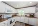 White kitchen with updated appliances and brown countertops at 4725 Cove Cir # 211, St Petersburg, FL 33708