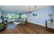 Bright living room with hardwood floors and large windows at 4725 Cove Cir # 211, St Petersburg, FL 33708