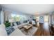 Open concept living room with hardwood floors and light blue walls at 4725 Cove Cir # 211, St Petersburg, FL 33708