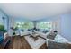 Spacious living room featuring light walls, wood flooring, and ample natural light at 4725 Cove Cir # 211, St Petersburg, FL 33708