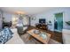 Living room with wood floors, neutral decor, and views into other rooms at 4725 Cove Cir # 211, St Petersburg, FL 33708