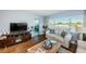 Living room with water views, comfortable seating, and a media console at 4725 Cove Cir # 211, St Petersburg, FL 33708