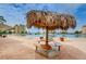 Relaxing patio area with a thatched umbrella and seating at 4725 Cove Cir # 211, St Petersburg, FL 33708