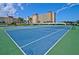 Two well-maintained tennis courts with green surrounding at 4725 Cove Cir # 211, St Petersburg, FL 33708