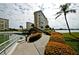 Scenic walkway leading to waterfront with lush landscaping and building views at 4725 Cove Cir # 211, St Petersburg, FL 33708