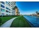 Waterfront walkway with lush landscaping and condo building at 4725 Cove Cir # 211, St Petersburg, FL 33708