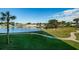 Scenic waterfront view with lush green landscaping and calm waters at 4725 Cove Cir # 211, St Petersburg, FL 33708